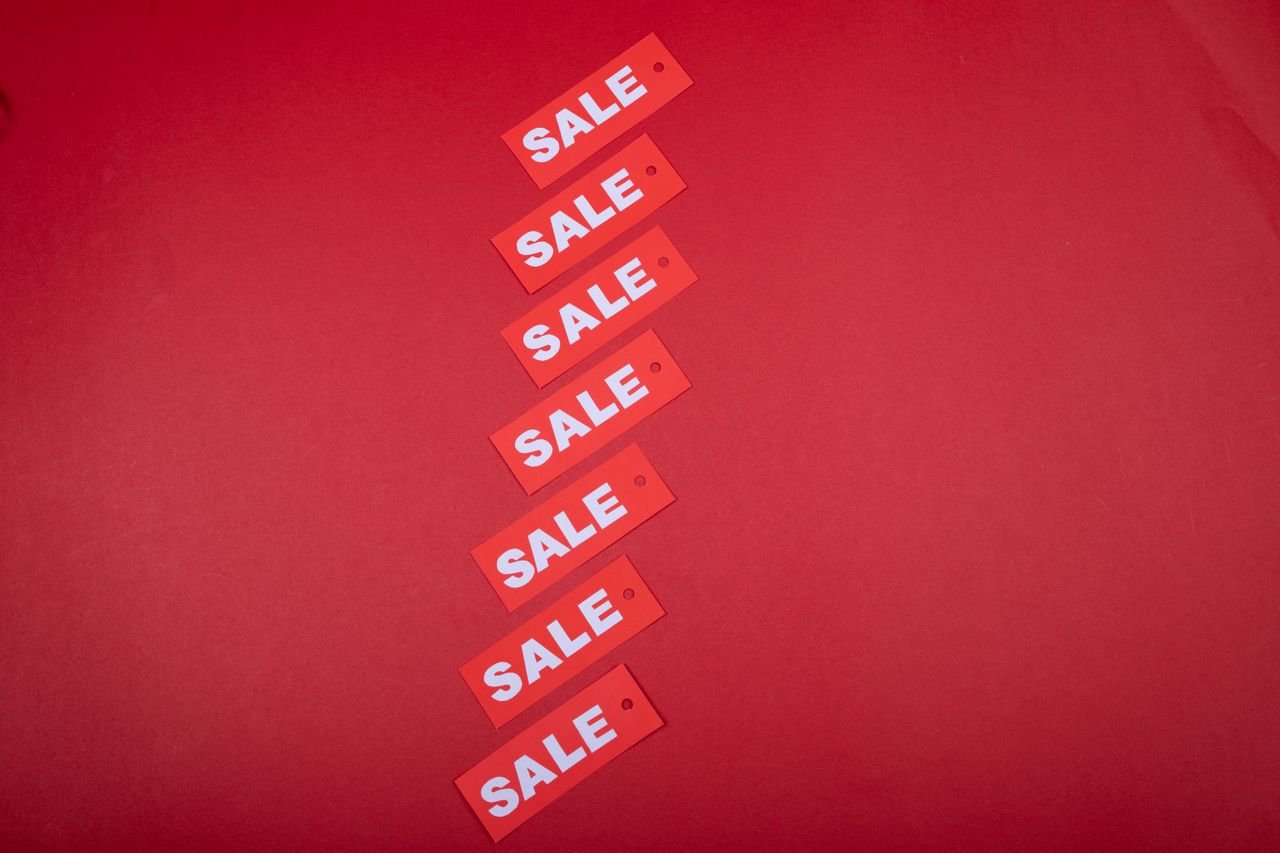services-cta Top view of red sale tags arranged on a vibrant red background for commercial use.